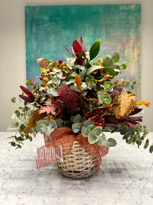 Arreglo floral en cesta en tonos burdeos